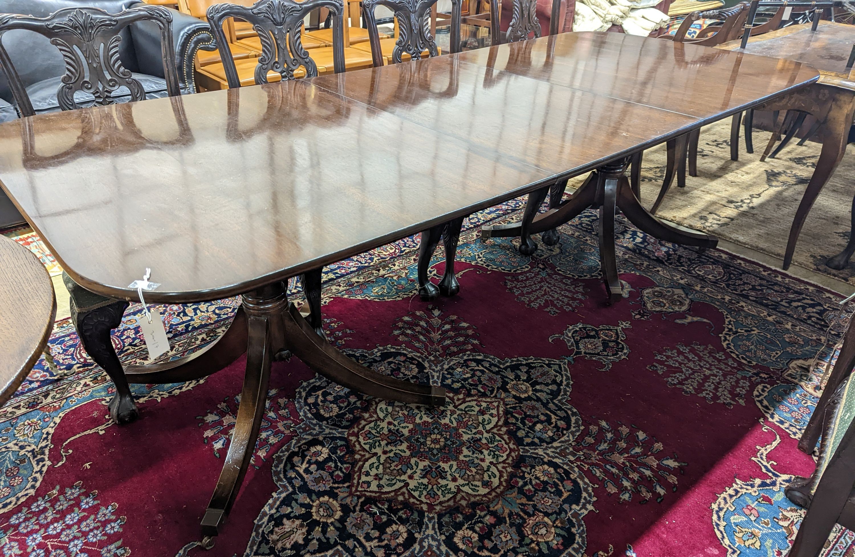 A reproduction George III style rectangular mahogany extending dining table, 241cm extended, one spare leaf, depth 104cm, height 74cm